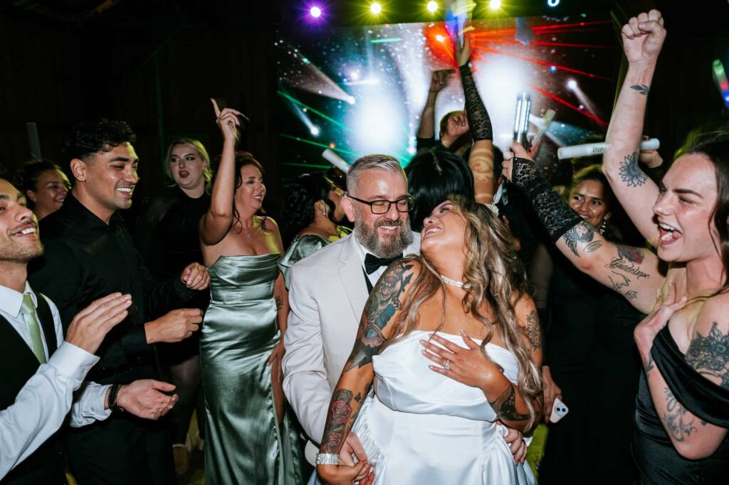 Portfolio 17 bride and. groom are having fun dancing during the reception at Destiny Ranch in Florida captured by Buckhead Wedding Photographer