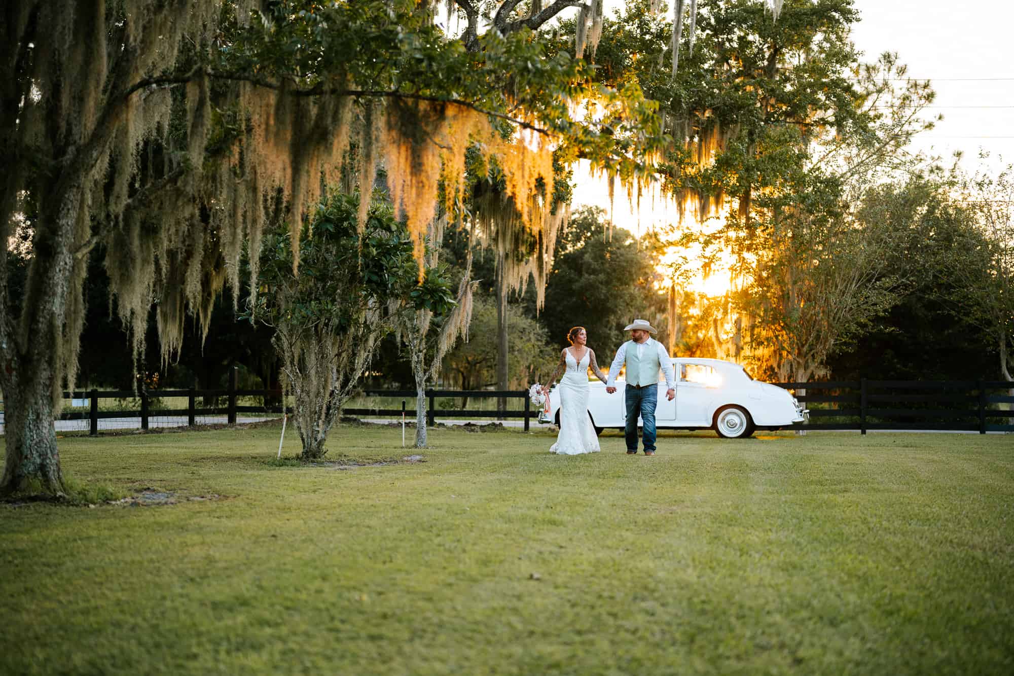 Sunset portrait of newlywed couple couple walking and looking at each other at south Georgia wedding venue