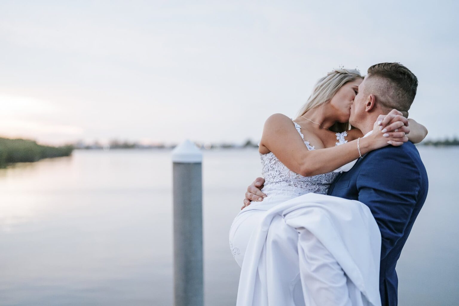 Kevin lifted Emily during their sunset portraits at their Florida Beach Wedding in Islamorada captured by Atlanta Wedding Photographer Peach State Weddings