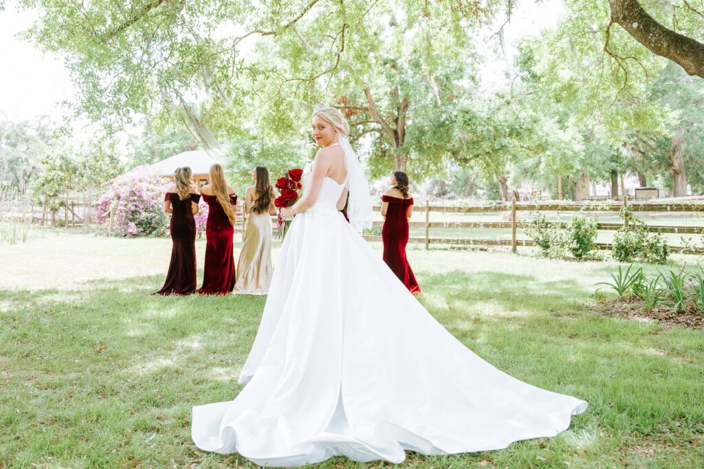 reveal of the bride with her bridesmaids - first time her best friends get to see her in her wedding dress before the wedding ceremony in Lakeland Florida at the Magnolia Building - photographed by Peach State Weddings