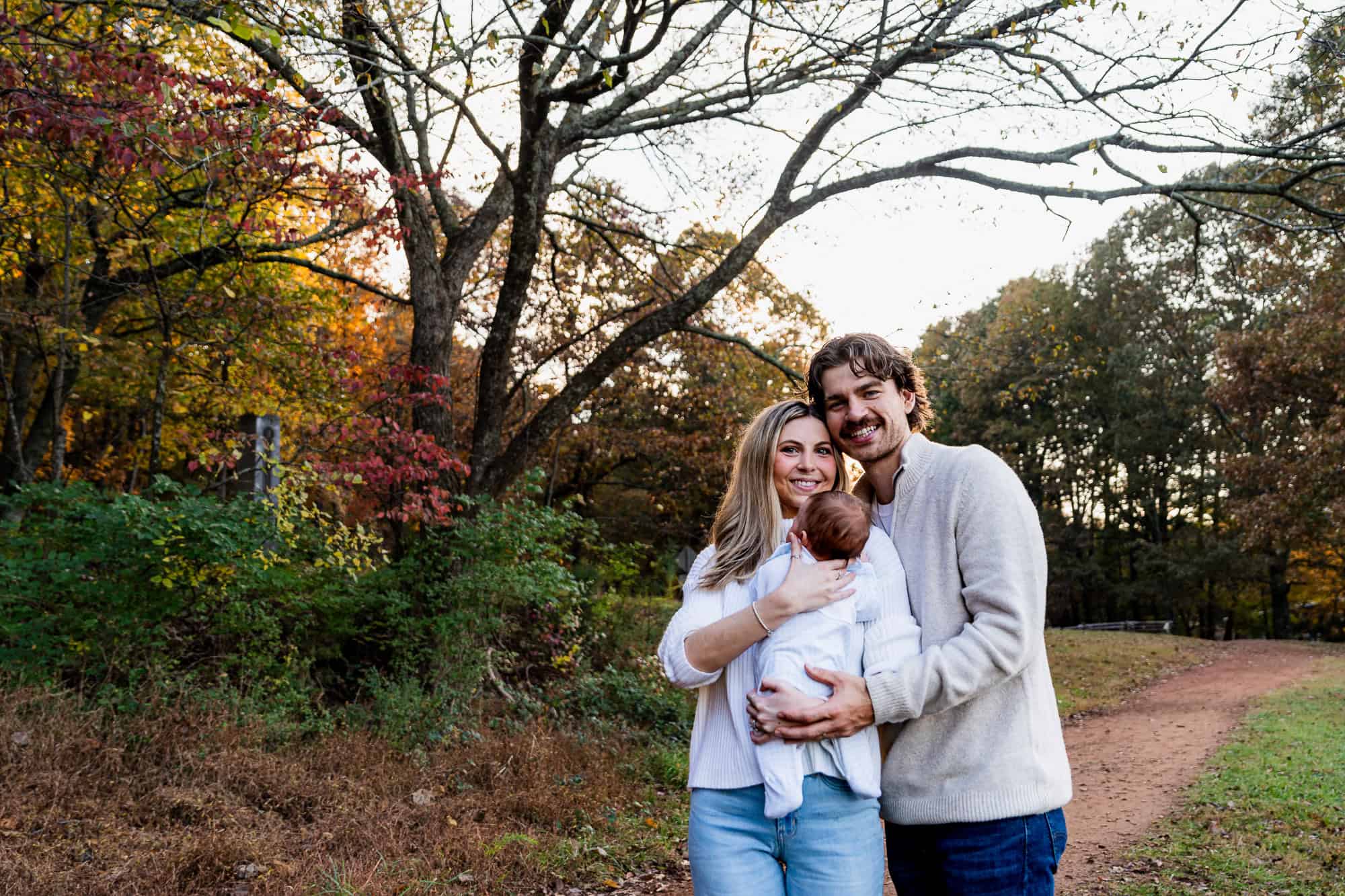 Fall family portraits at Kennesaw Mountain featuring Zach and Hannah and their newborn baby at sunset