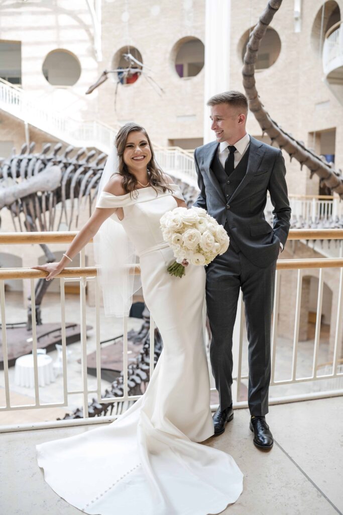 Bride and groom having a relaxed moment at the Fernbank in front of the Argentinosaurus and Giganotosaurus 