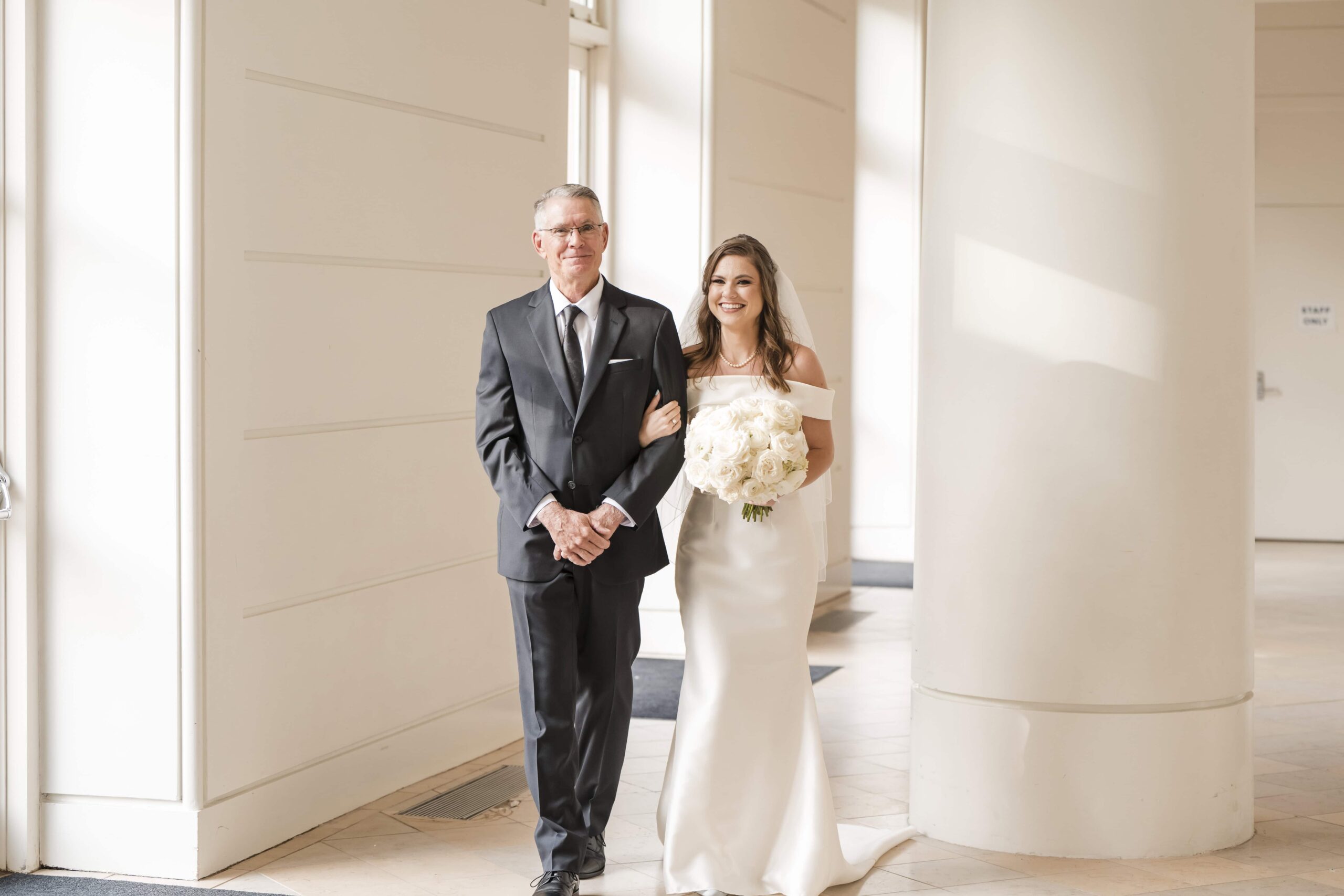 Father is walking his daughter down the aisle at the Fernbank Museum. Photographed by Georgia Wedding Photographer. Timeless wedding photography in Atlanta GA.