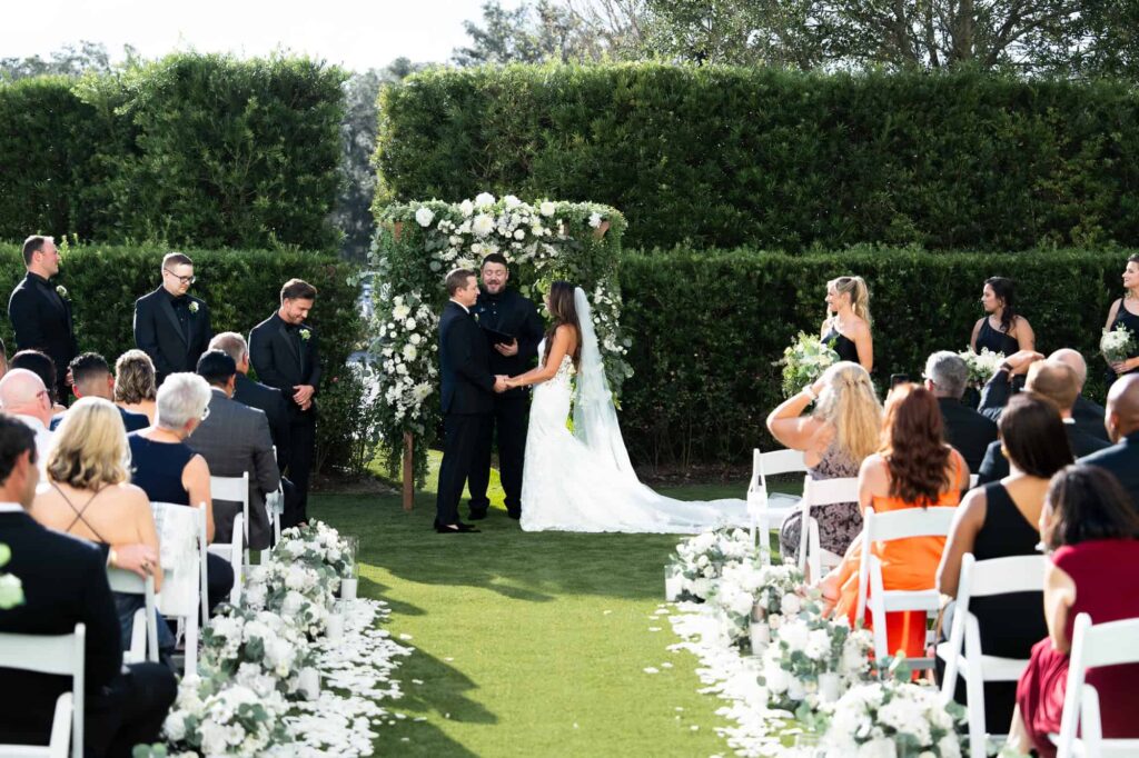 A scenic outdoor wedding ceremony in the rose garden at the World Equestrian Center, captured by Atlanta Georgia wedding photographer Peach State Weddings.