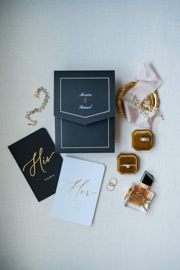 High-end wedding day details including gold-foil vow books and YSL perfume for a World Equestrian Center wedding.