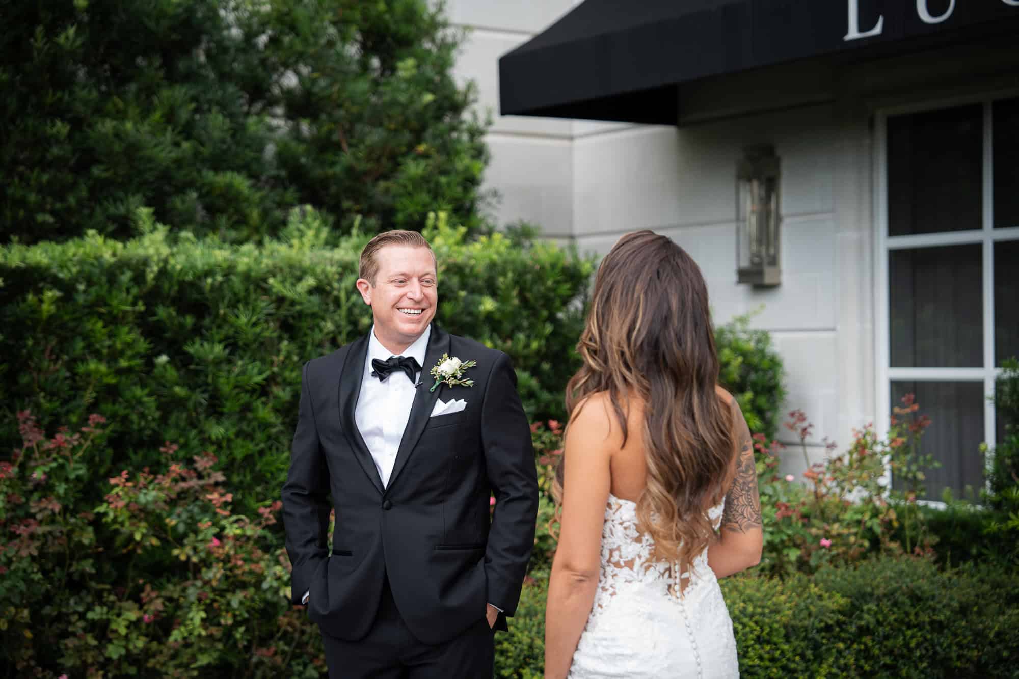 Editorial wedding photography of a first look among the blooming roses at the World Equestrian Center in Ocala by an Atlanta Georgia destination photographer.
