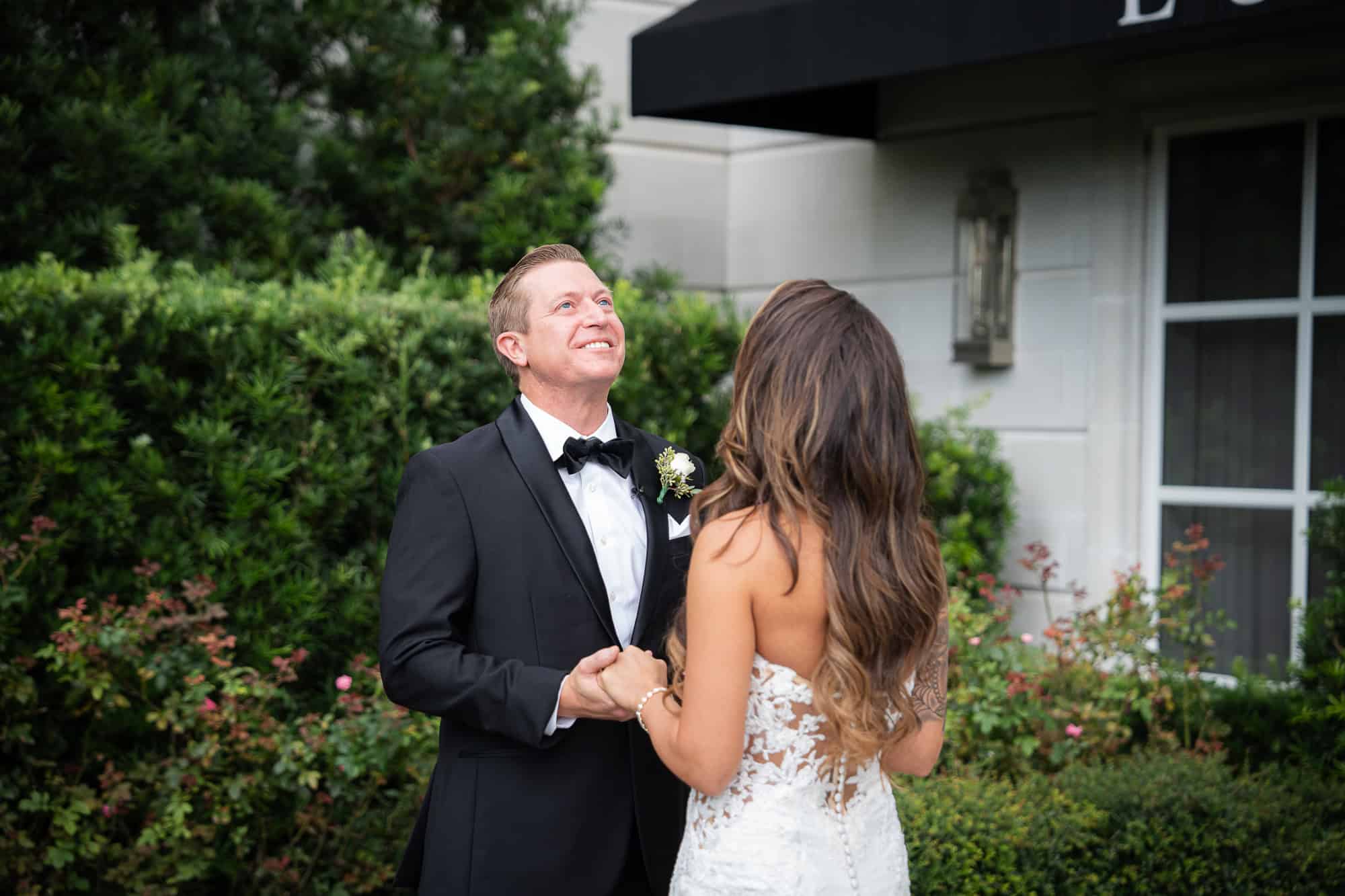 Timeless and intentional first look moment in a lush rose garden, documented by Atlanta Georgia wedding photographer Peach State Weddings.