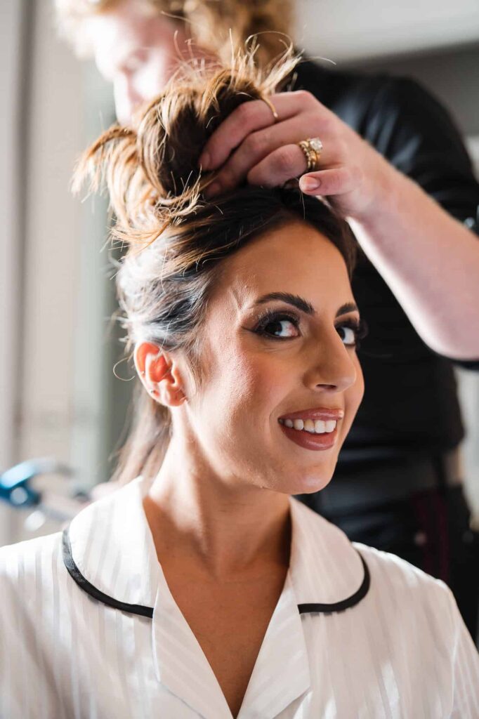 Close-up of a bride having her hair styled for her World Equestrian Center wedding by a destination wedding photographer.
