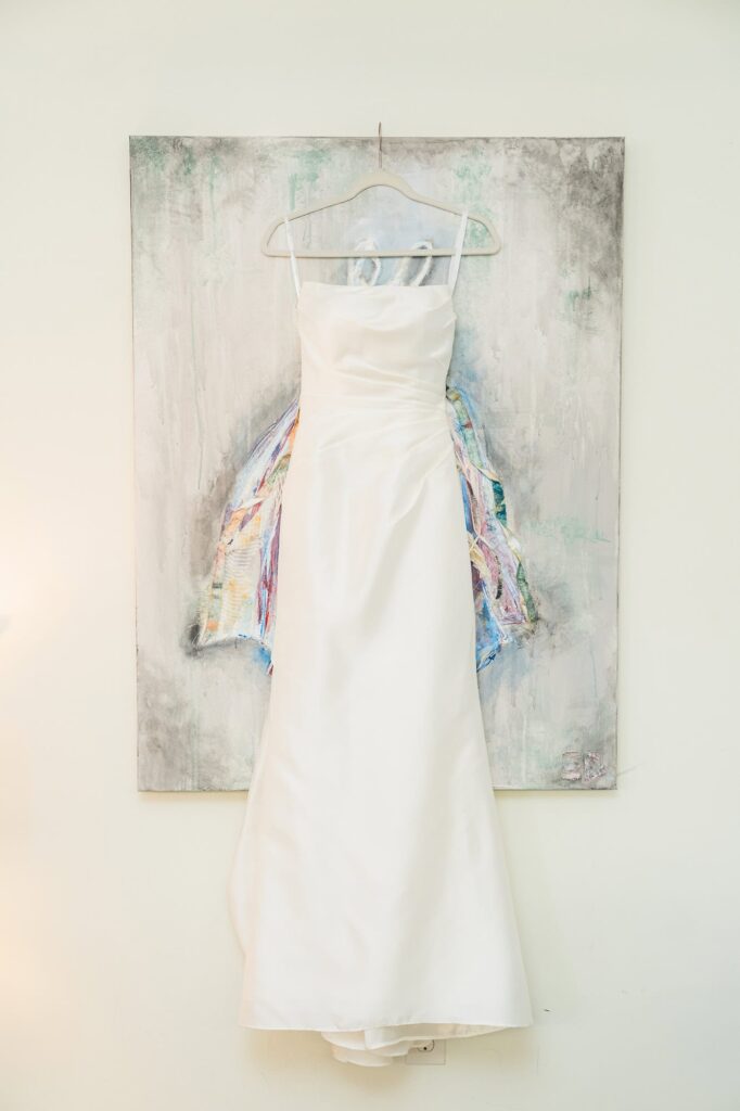 Hannah's wedding dress hanging in the bridal cottage at the venue at Daisy Hill, a wedding venue in Fayetteville, GA