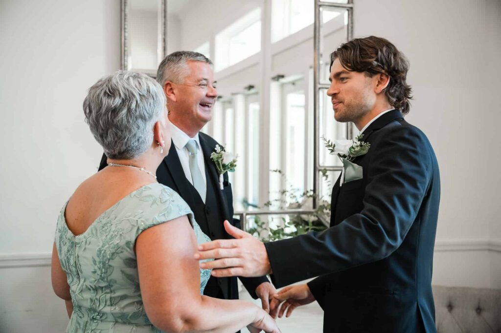 Georgia photographer capturing the groomand his parents just moments before the wedding ceremony at the venue at daisy hill