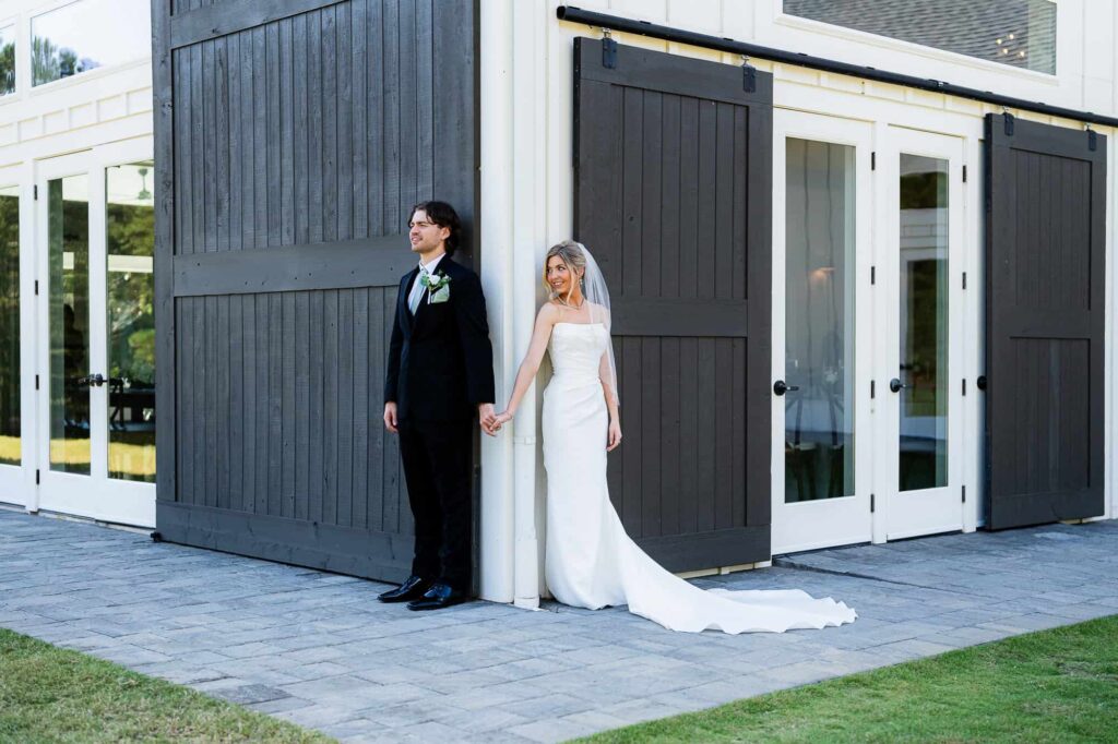 Intimate first touch between Hannah and Zach at The Venue at Daisy Hill, a modern barn wedding venue in Fayetteville GA.