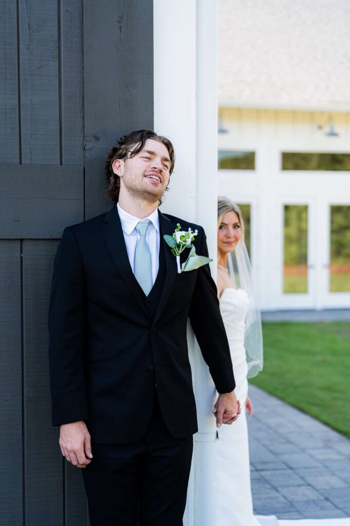 Close up of Hannah and Zach’s interlocking hands during a private wedding first touch at a lakeside Georgia wedding.