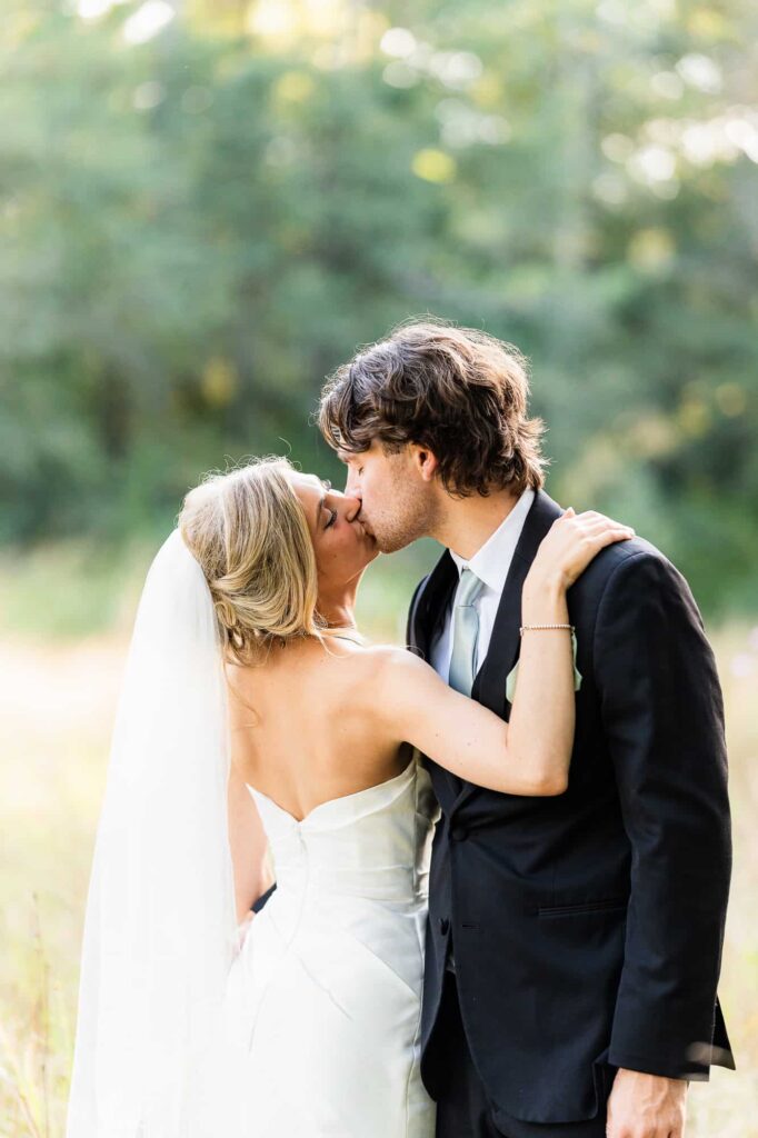 Romantic bride and groom sunset photos by the lake at Daisy Hill; a premier outdoor wedding venue in Fayetteville, GA.
