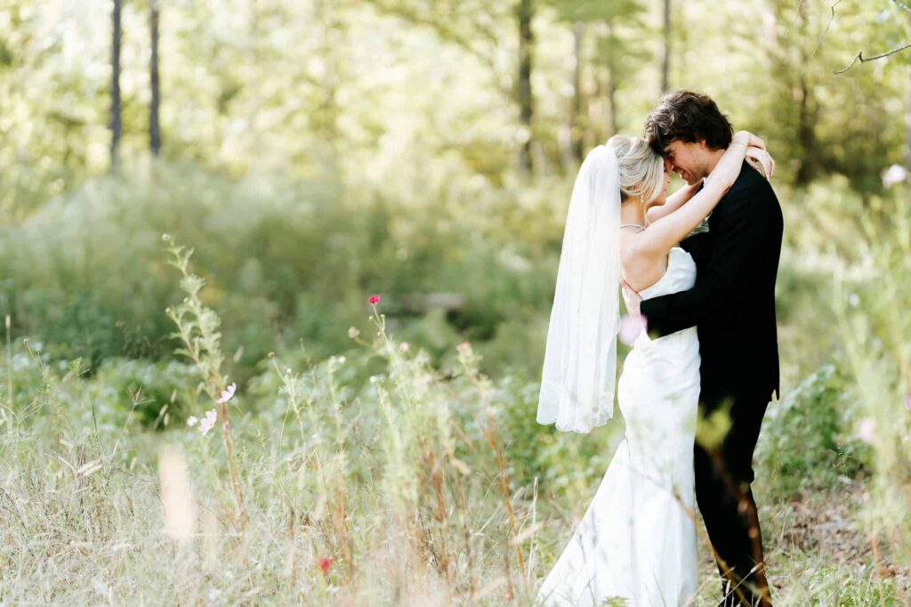 Intimate wedding portrait of a couple embracing during the "golden hour" at a modern barn wedding in Atlanta.