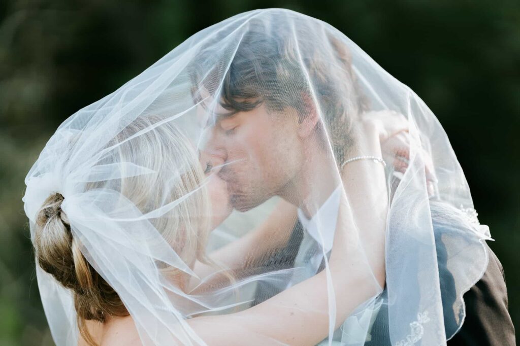 Close-up of the bride’s veil catching the sunset light during golden hour portraits in Fayetteville.