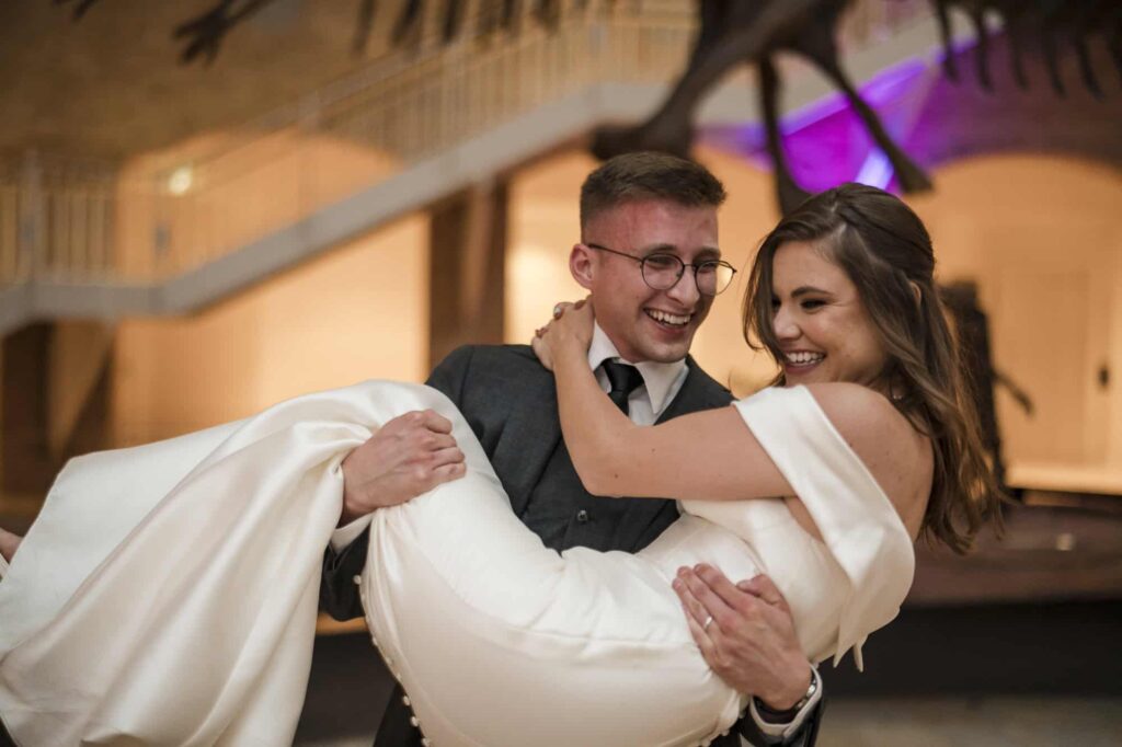 Atlanta wedding photographers capture bride and groom during their first dance in the great hall at the Fernbank  Museum, a top 10 Atlanta wedding venue 