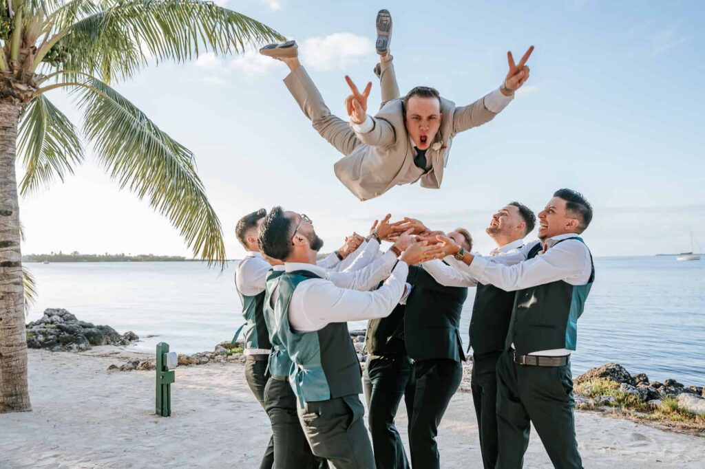 Key-Largo-Wedding-Best-Atlanta-Photographer-captured-groom-being-thrown-in-the-air-by-his-Groomsmen